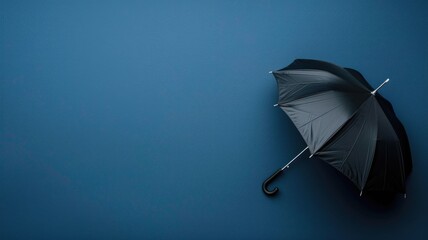 Black umbrella open on blue background