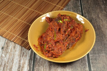 Deep Fried gourami fish dressing with spicy red curry sauce serving on the plate. Famous hot and...
