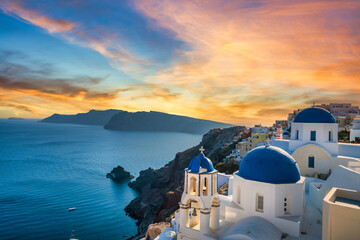 Blue bell domes of Oia village on Santorini island at sunset. Greece
