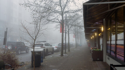 Main shopping strip at UniverCity Highlands residential community, BC, shrouded in winter mist.