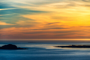 Fototapeta premium top view of a sunset over The city of Alesund and the sea during a sunny evening, Norway