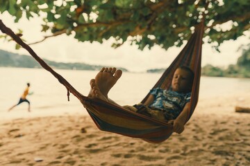 Boy relaxing in hammock on beach