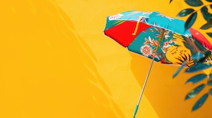 Colorful umbrella with floral pattern on bright yellow background plant shadows