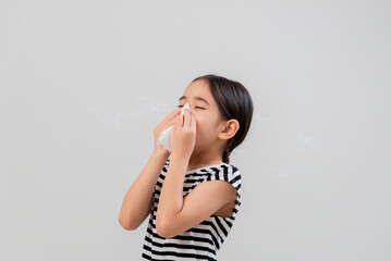 Little asian kid girl with allergy sneezing