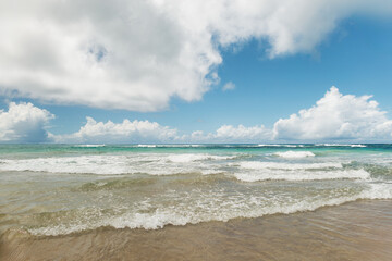 View of a tropical beach with clouds on the horizon in Porto de Galinhas, Brazil.