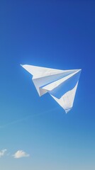 Paper plane soaring high in a crystal clear blue sky, symbolizing freedom and dreams