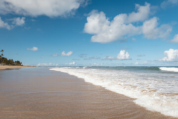 Obraz premium View of a tropical beach with clouds on the horizon in Porto de Galinhas, Brazil.