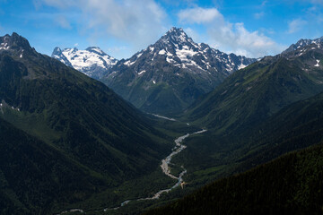 Fototapeta premium View of Mount Pshish - the highest peak near the village of Arkhyz and the valley of the Psysh River on a sunny summer day, North Caucasus, Karachay-Cherkessia, Russia