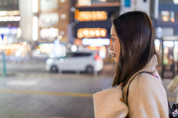 A Chinese woman in her 20s taking a walk at night in front of the station in Omiya Ward, Saitama...