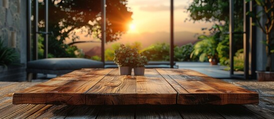 A simple wooden table displays a variety of lush potted plants, placed in front of a large window with natural light streaming in