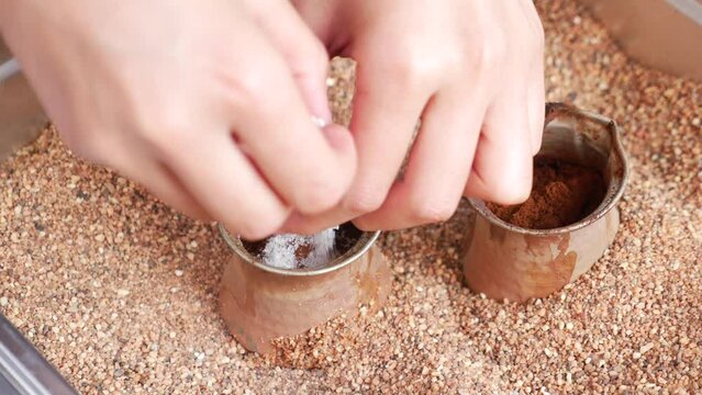 top view of making traditional turkish coffee on sand 
