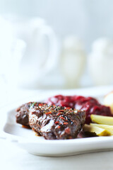 Beef steak with potato dumplings on bright background. Close up. Copy space.