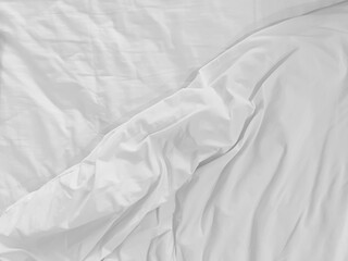 Unmade bedding sheets top view background. White wrinkled blanket after sleeping. Messy duvet. Cozy...