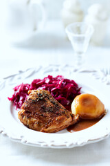 Fried pork ribs with potato dumplings on bright background. Close up.