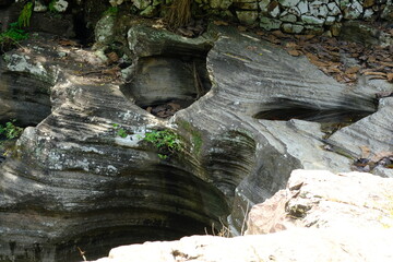 river banks with layered sedimentary rocks. Sedimentary rock, is a type of rock formed by sedimentation and cementation that can occur on the earth's surface and underground or in water. batu sedimen.