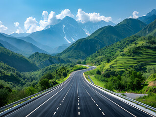 Fototapeta premium A long, empty highway winds through a valley between mountains.