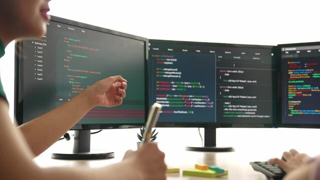 Back end software developer engineer for computer programming working together on debugging writing computing code, solving complex algorithms display on monitor in office. Burgeoning