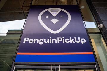 Naklejka premium Penguin Pick Up logo sign. Toronto, Canada - April 29, 2024.