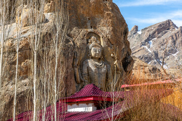 Stone carving of Buddha in a mountainside at the Mulbekh Buddhist Monastery in northern India
