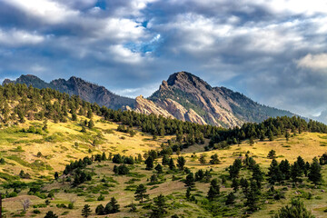 Flatiron Mountains in Boulder, Colorado, scenic greenery trees clouds rugged peaks, majestic vast panoramic view