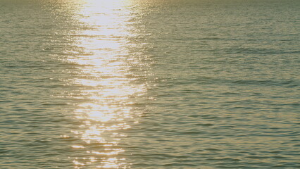 Calm Sea With Sun Flare. Dots Of Beautiful Orange Shining Are Seen On The Water Surface. Slow...