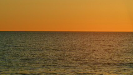 Obraz premium Ocean At Sunset. Right Burning Sunset Above Sea. Sun Is Setting Over Sea Or Ocean. Slow motion.