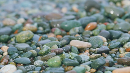 Pebble Beach Natural Background. Pebbles Under Water. Colorful Multicolored Pebbles On Seashore....