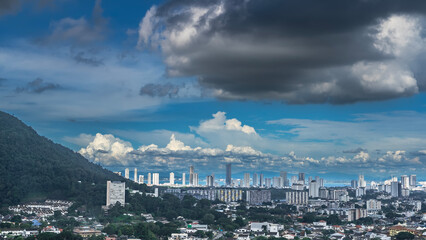 Panorama of the modern city. Skyscrapers against a background of blue sky and clouds. Multi-storey...