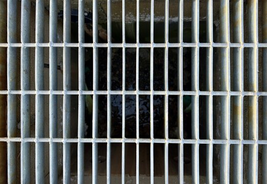 a overhead view of a metal storm drain grid as an industrial background or detailed industry backdrop