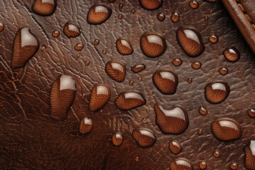 Water droplets on brown leather, texture pattern for background 