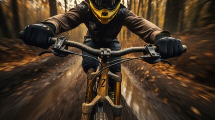 Dynamic front view of mountain biker speeding through autumn forest, focusing on the road ahead