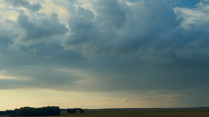Gray Rainy Clouds Float Across Dark Sky. Tornado Clouds. Natural Background. Rainy Sky. - obrazy, fototapety, plakaty