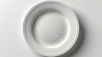 White round plate with a thin raised edge sits on a white surface.