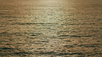 Wavy Orange Rippling Sea Water. Glittering Sea Surface. Sunlight Makes Sea Orange.