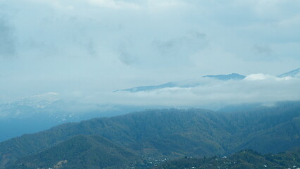 Enchanting Dance Of White Clouds. The Top Of The Mountain Covered With Snow.