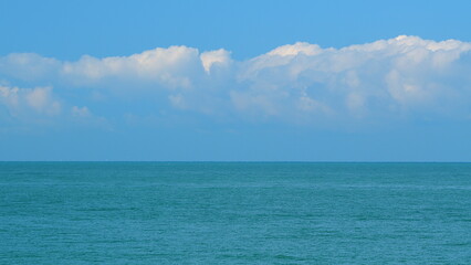 Deep Blue Sea With Scenic White Clouds In Blue Sky. Wonderful Nature Clouds With Sea. Still.