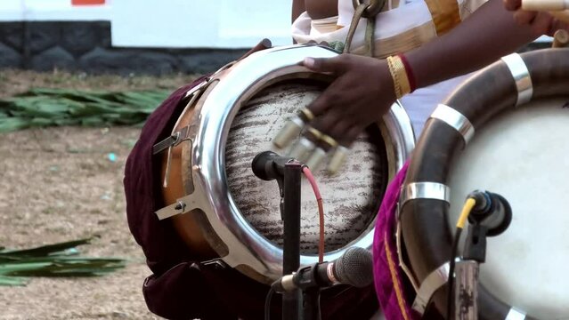 Artist playing Thavil, a South Indian percussion musical instrument	