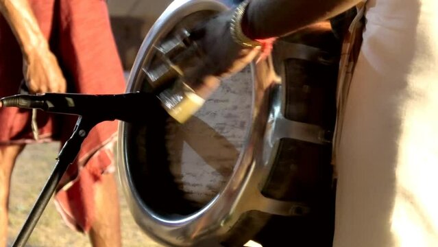 Artist playing Thavil, a South Indian percussion musical instrument	