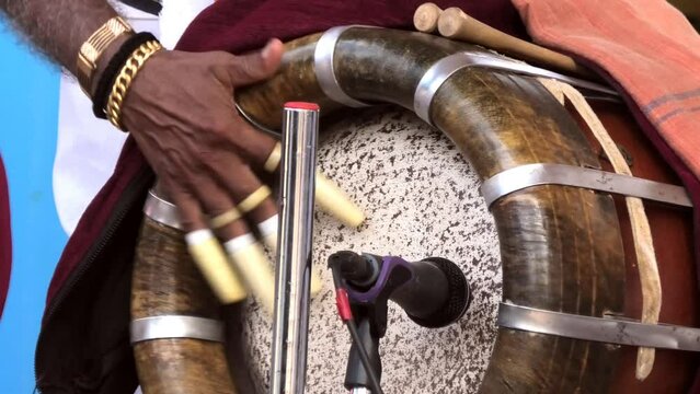 Artist playing Thavil, a South Indian percussion musical instrument	