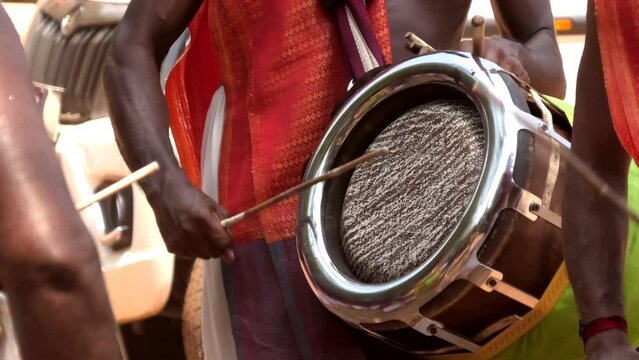 Artist playing Thavil, a South Indian percussion musical instrument	