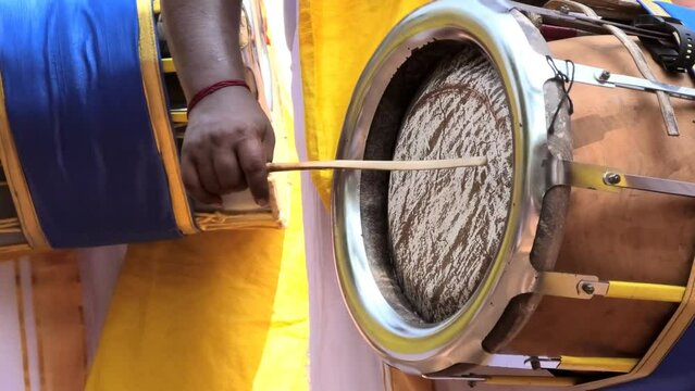 Artist playing Thavil, a South Indian percussion musical instrument	