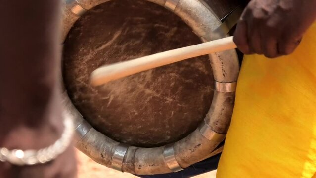 Artist playing Thavil, a South Indian percussion musical instrument	