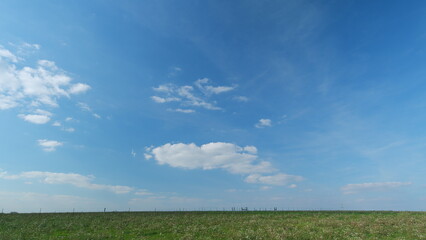 Blue Sky With White Clouds. Green Grass Field Agriculture Farm Concept. Calm And Peaceful. - obrazy, fototapety, plakaty