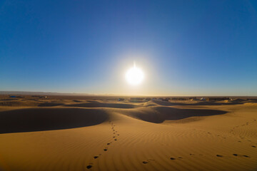 Fototapeta na wymiar A sunrise of desert at Mhamid el Ghizlane in Morocco wide shot