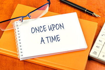 Once upon a time text inscription on the notebook lying on the notebook on the businessman's office...