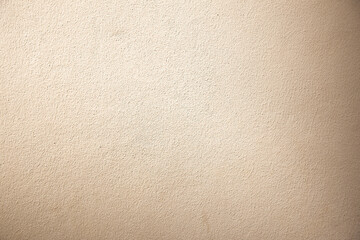 Cream colored cement walls Plaster the surface to be rough and textured, used for making backgrounds or wallpapers that look classic.