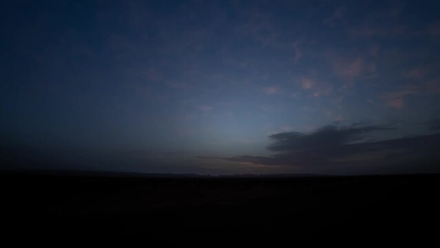 A sunrise timelapse of desert at Mhamid el Ghizlane in Morocco wide shot zoom
