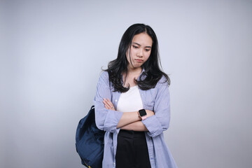 Upset Young Female Student Crossing Arms and Feeling Bored Isolated on White Background 