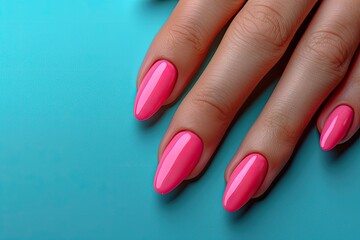 Pink manicure close up. Young woman hands with trendy pastel manicure on blue background. Summer fashion manicure.