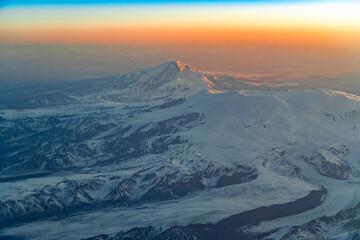 Aerial view of snow mountain in morning sunlight in Alaska